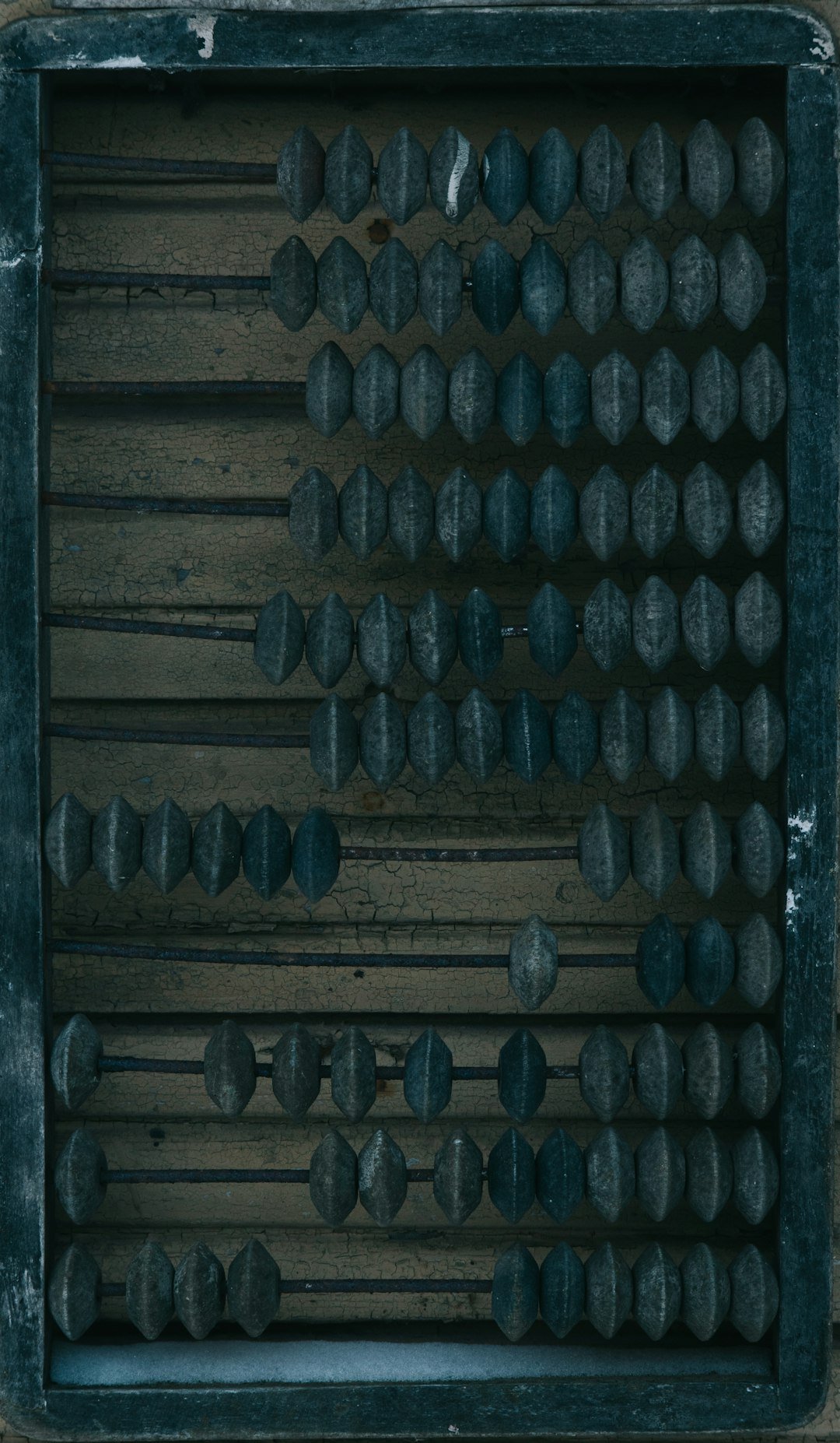 a wooden box filled with lots of black knobs