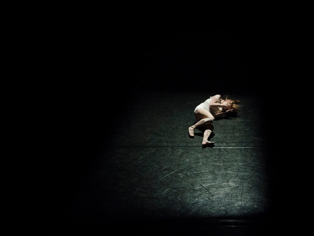 a person standing on a tennis court in the dark