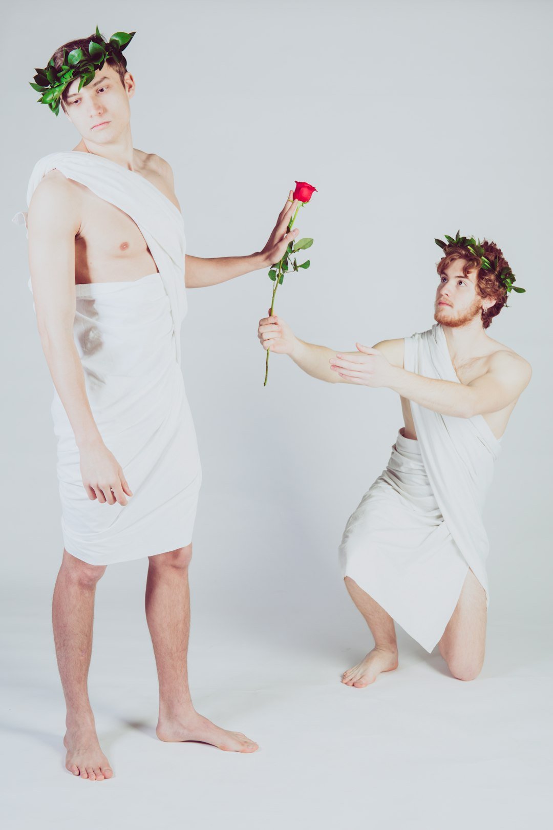 man giving rose to another man